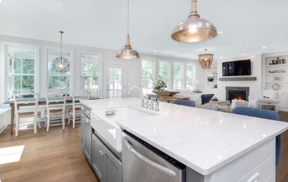 Open-concept kitchen with large island, pendant lighting, and connected living space